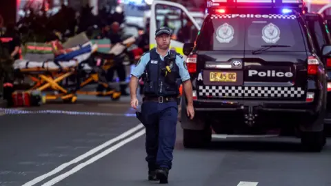 Getty Images A police officer at the scene in Bondi