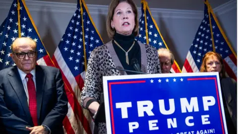 Getty Images Mrs Powell with Mr Giuliani (left)