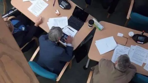 Val Haynes Councillor Charlie Dennis using mobile phone