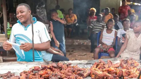 BBC Man selling chicken in a street of Arondizuogu during the Ikeji Festival in Nigeria