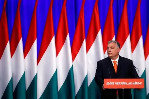 Reuters Hungarian Prime Minister Viktor Orban delivers his annual state of the nation speech in Budapest, Hungary, on 12 February 2022. Slogan reads "Let"s go forwards, not backwards!"