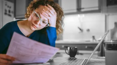 Getty Images A student looking at her finances