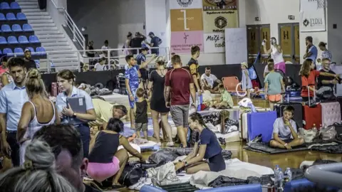 Reuters One of the sports halls in Rhodes was cleared to accommodate stranded holidaymakers on Saturday night