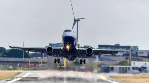 A plane takes off from London City Airport