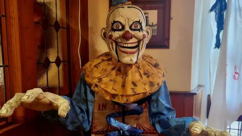 Leeann Austin/PA Wire A spooky decoration of a man with his hands outwards and showing an evil smile