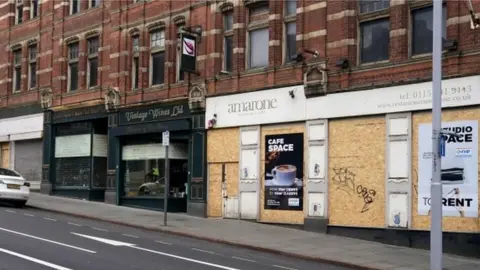 PA Media Boarded up shops on Nottingham