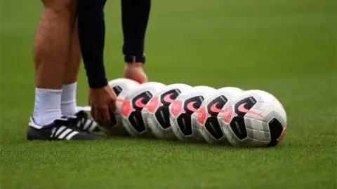 PA Media Adidas football boots and Nike balls