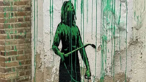James Peak/The Banksy Story A stencilled painting of a figure holding a pressure sprayer