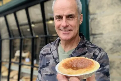 The Bakewell Pudding Shop Phil Vickery with a pudding