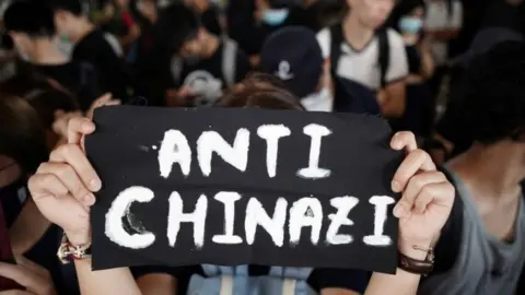 Reuters A woman at West Kowloon Law Courts on Wednesday, where 96 anti-government protesters were due to appear