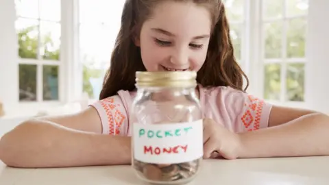 Getty Images Girl saving her pocket money (posed by model)