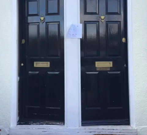 PA Double doors with a sign offering toilets, tea and charging ports