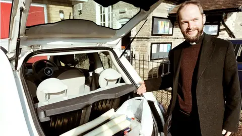 Will Lyon Tupman Reverend Will Lyon Tupman loading the car with candles