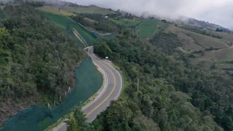 Migrants walk along the road between Pamplona and Bucaramanga on 1 October.