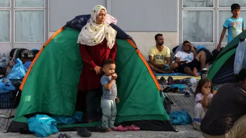Reuters Migrants near burnt-out Moria camp, 16 Sep 20