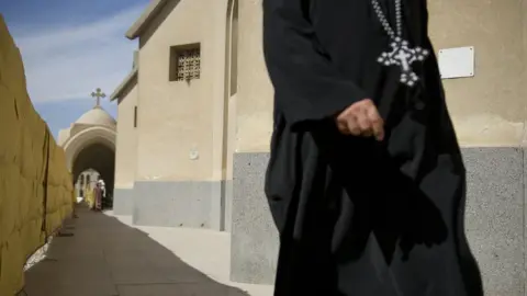 Getty Images A Coptic Christian priest enters Saint Mark's Cathedral on November 4, 2012 in Cairo,