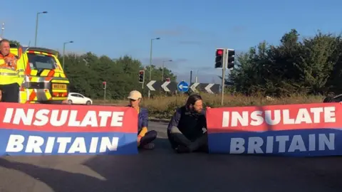 Insulate Britain campaigners sit on the M25