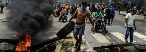 AFP Anti-government activists build a barricade in Valencia