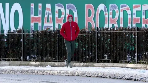 Getty Images Sinn Fein billboard in West Belfast calling for "No Hard Border"