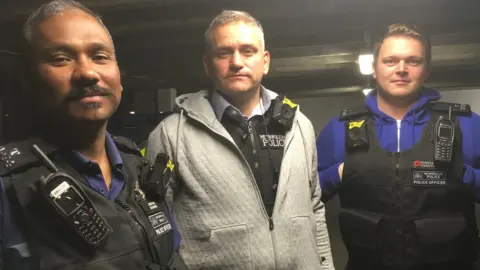 Inspector Paul Davey (centre) with PC Thavachselvan Suthesan and PC Tom Maddon