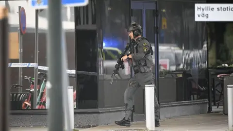 AFP via Getty Images Police secure the area after two people were shot at Emporia shopping centre in Malmo, Sweden