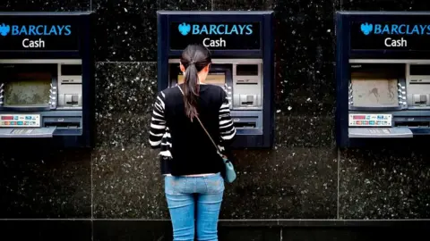 Getty Images Woman at Barclays cash point