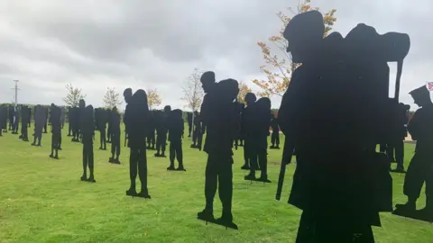 BBC Silhouette statues standing on a grassy space