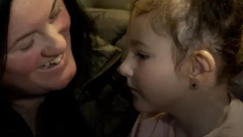 A mother and her daughter smile in a hospice