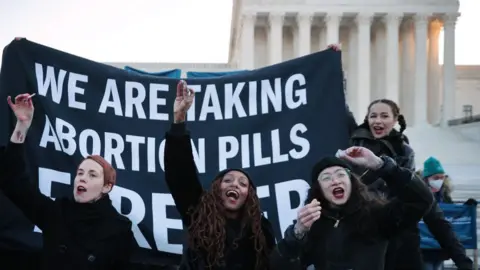 Getty Images Protesters take abortion pills outside the US Supreme Court earlier this month