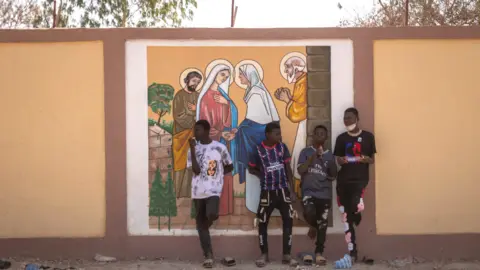 AFP Boys in front of a religious mural outside Ouagadougou, Burkina Faso - Sunday 5 February 2023