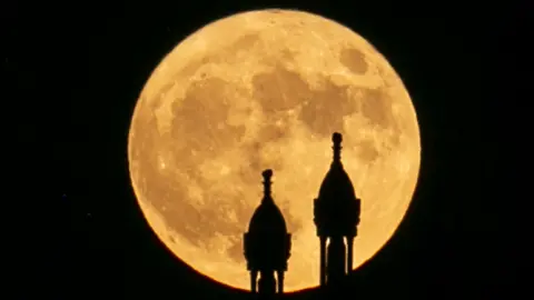 AFP Minarets seen against supermoon in Tunis, Tunisia - Wednesday 13 July 2022