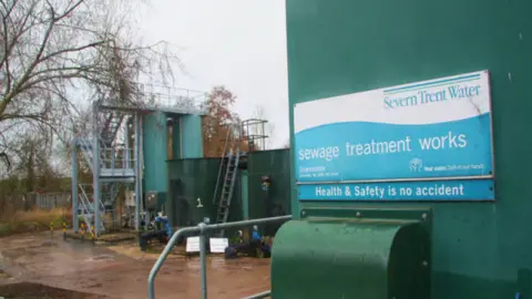 Signage at the plant reads 'sewage treatment works'