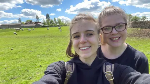 Danielle Kinton Danielle Kinton and her partner with sheep in the background