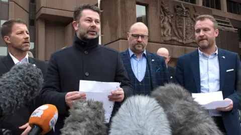 Getty Images Abuse victims of former football coach Barry Bennell (L-R) Steve Walters, Gary Cliffe, Chris Unsworth and Micky Fallon speak outside Liverpool Crown Court on 19 February 2018