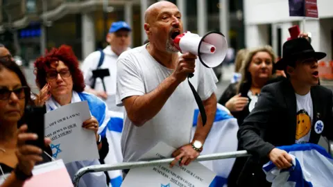Reuters Protesters outside the NEC meeting