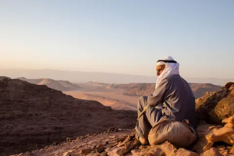 Wael Hussein Al Sayed  A tribesman of the Garasha looks over the rugged deserts of the Alegat
