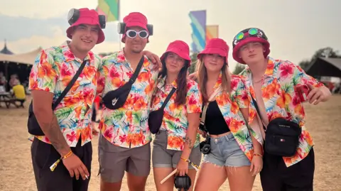 A group of revellers in colourful Hawaiian shirts at Truck Festival.