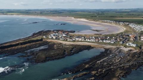 An aerial view of Beadnell showing the bay of Seahouses 