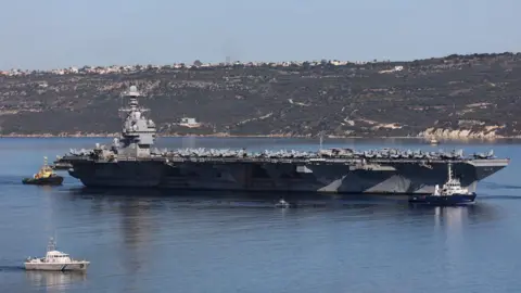 Reuters The USS Gerald R Ford aircraft carrier leaves Souda Bay, Crete, Greece (26 February 2026)
