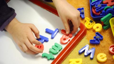 Children playing with letters