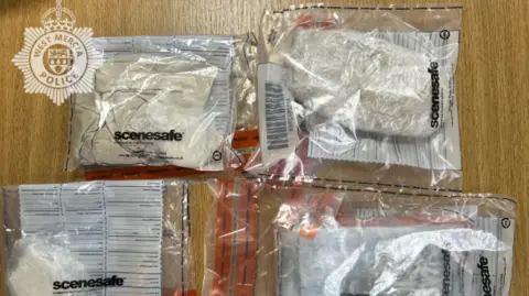 Drugs found at the scene are shown in plastic bags, labelled scenesafe, in the photograph that has been issued by police.