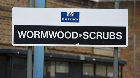 PA Media Wormwood Scrubs sign with white writing on black background
