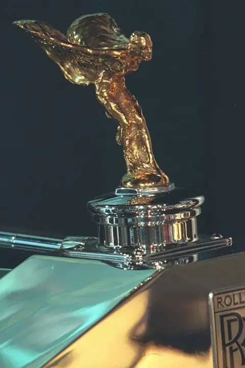 Getty Images A gold Spirit of Ecstasy statuette on top of a Rolls-Royce