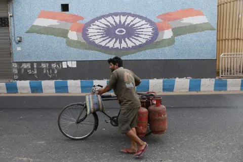 NurPhoto via Getty Images LPG gas seller in India