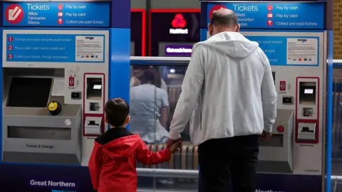 A father and son who bought tickets in a machine in a train station