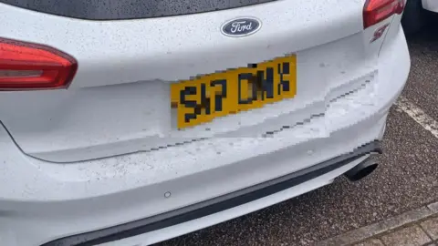 South Yorkshire Police The back of a white Ford car with the numberplate blurred