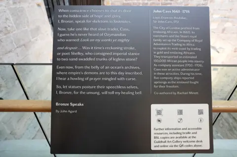 PA Media A plaque condemning slave traders is attached to a statue of John Cass at the Guildhall in London.