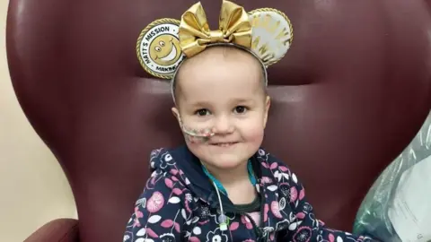 Matt Denning A little girl sitting on aa chair