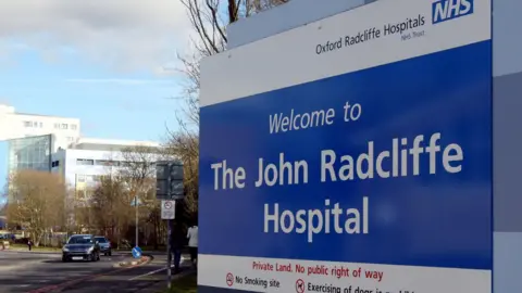 A big sign saying 'Welcome to The John Radcliffe Hospital' 