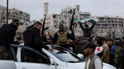 People celebrate in Sheikh Maksoud neighbourhood, following a ceasefire agreement that ended violent clashes in Aleppo this week.